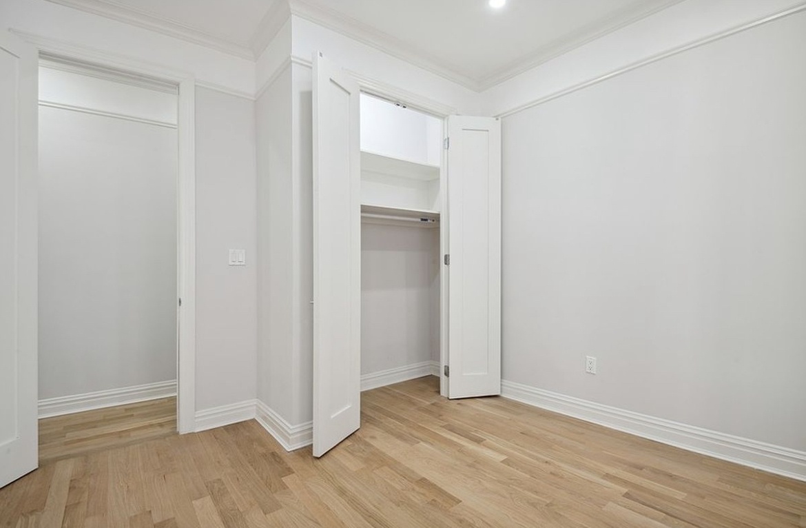 575 Riverside Drive, Unit 42 Manhattan, NY 10031 - Photo 4 of 12 an empty room with wooden floor and entrance