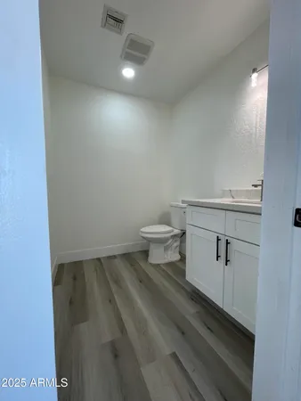 a kitchen with stainless steel appliances kitchen island wooden floors and view living room