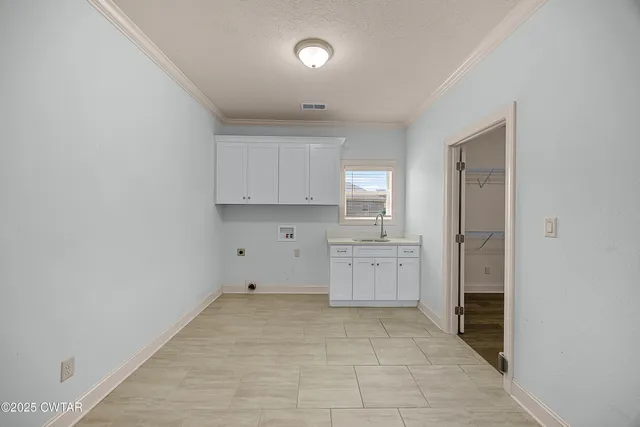 a large white kitchen with a sink