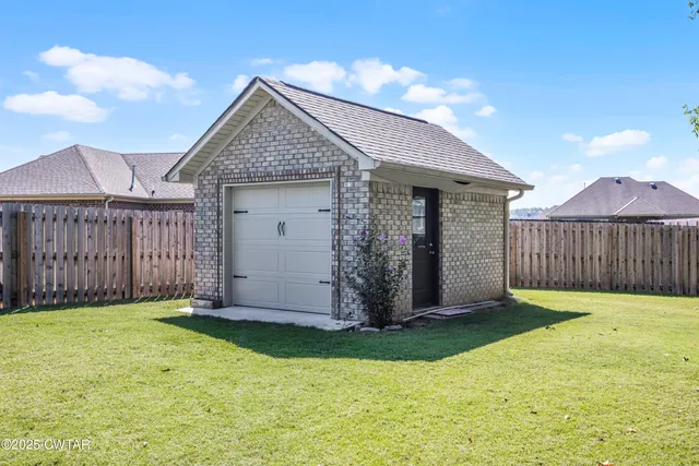 a view of a house with wooden fence
