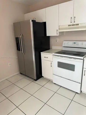 a kitchen with appliances and cabinets