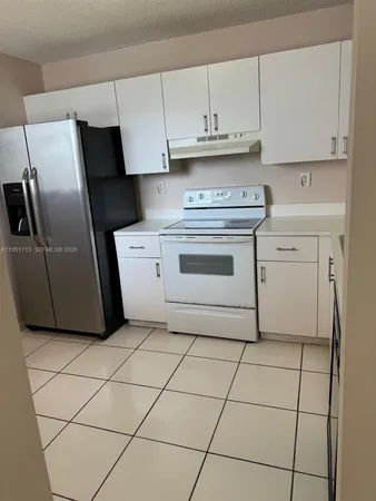 a kitchen with cabinets and appliances