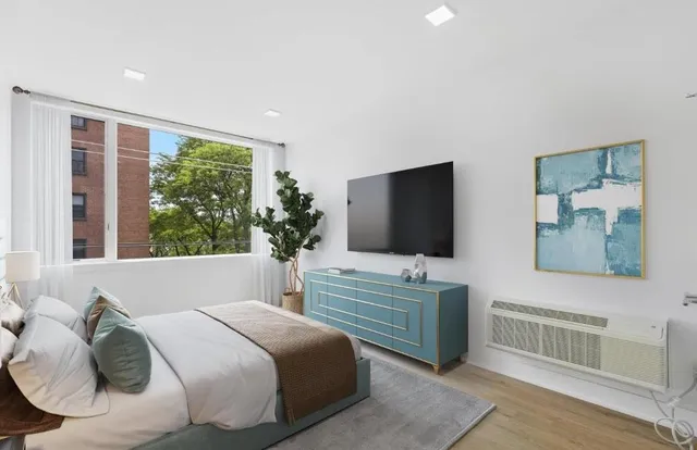 a bedroom with a bed and a flat screen tv