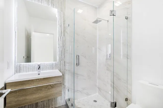 a bathroom with a shower and a sink