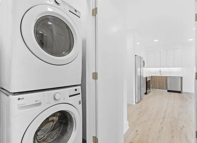 a view of a hallway with washer and dryer