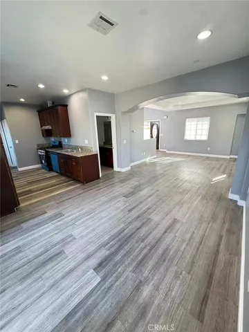 a view of a room with wooden floor and staircase