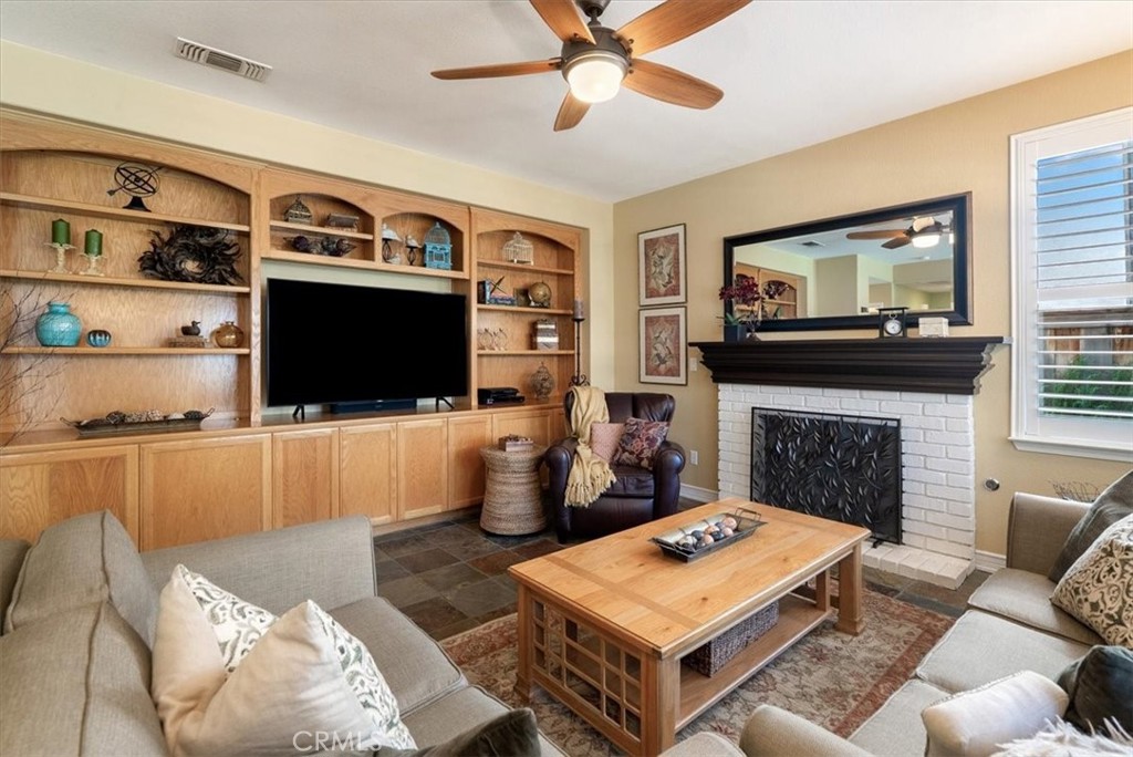 1945 Fieldstone Circle Paso Robles, CA 93446 - Photo 15 of 48 a living room with furniture a flat screen tv and a fireplace