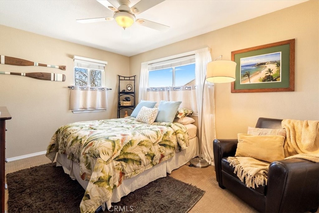 1945 Fieldstone Circle Paso Robles, CA 93446 - Photo 25 of 48 a bed sitting in a bedroom next to a window and a chandelier