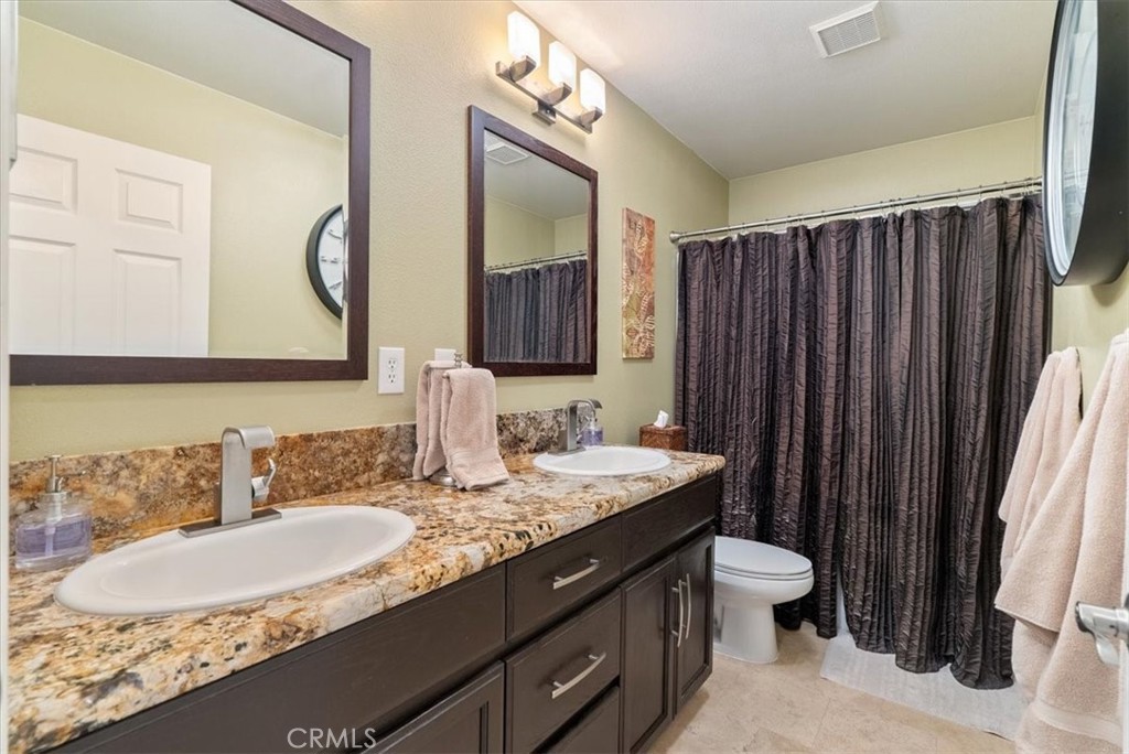1945 Fieldstone Circle Paso Robles, CA 93446 - Photo 26 of 48 a bathroom with a granite countertop sink and a mirror
