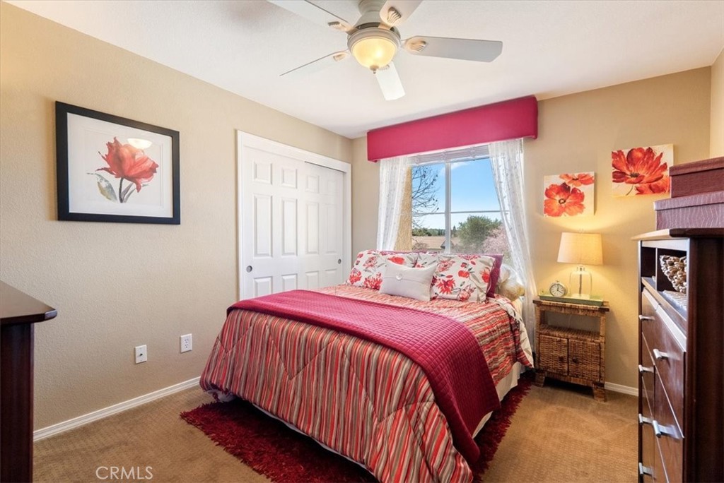 1945 Fieldstone Circle Paso Robles, CA 93446 - Photo 27 of 48 a bedroom with a bed and a chandelier