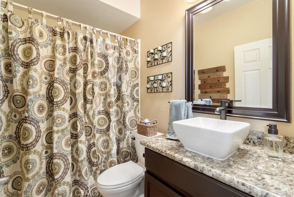 1945 Fieldstone Circle Paso Robles, CA 93446 - Photo 29 of 48 a bathroom with a granite countertop sink and a mirror