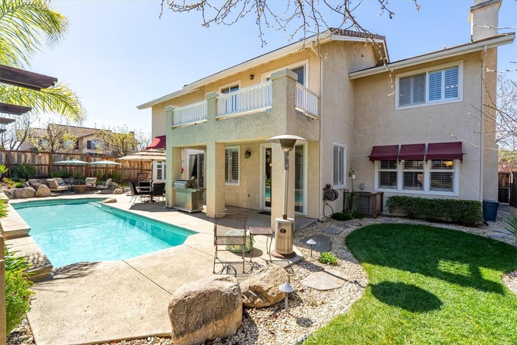1945 Fieldstone Circle Paso Robles, CA 93446 - Photo 31 of 48 a patio with a table and chairs and a umbrella