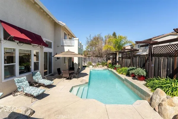 a view of a house with a backyard porch and sitting area