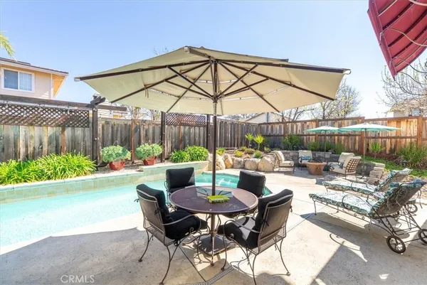 a view of a patio with couches table and chairs and potted plants