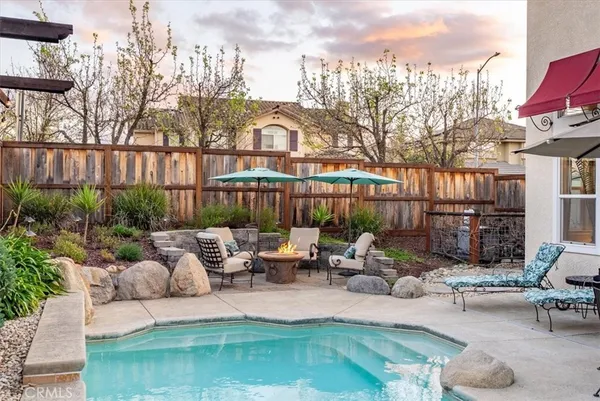 a view of a patio with furniture and iron fence