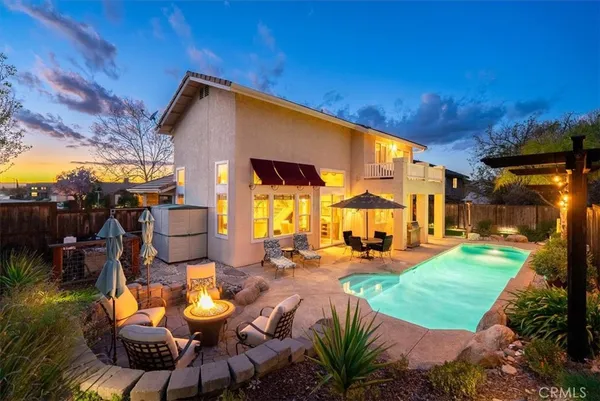 a view of a patio with swimming pool table and chairs