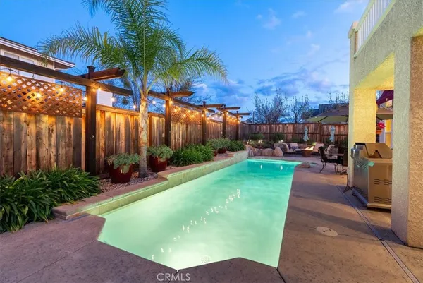 an aerial view of a house with a yard and lake view