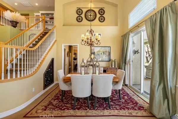 a kitchen with a dining table chairs and refrigerator