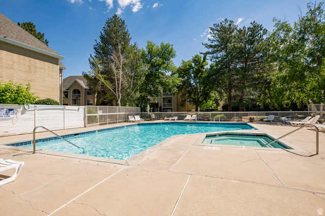 1221 Waterside Cove, Unit 11 Midvale, UT 84047 - Photo 16 of 23 Outdoor swimming pool with integrated spa and surrounding concrete decking
