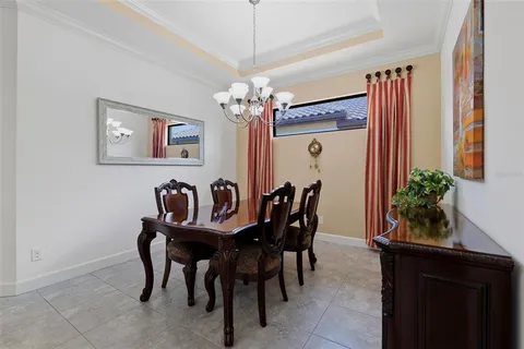 a view of a dining room with furniture and chandelier