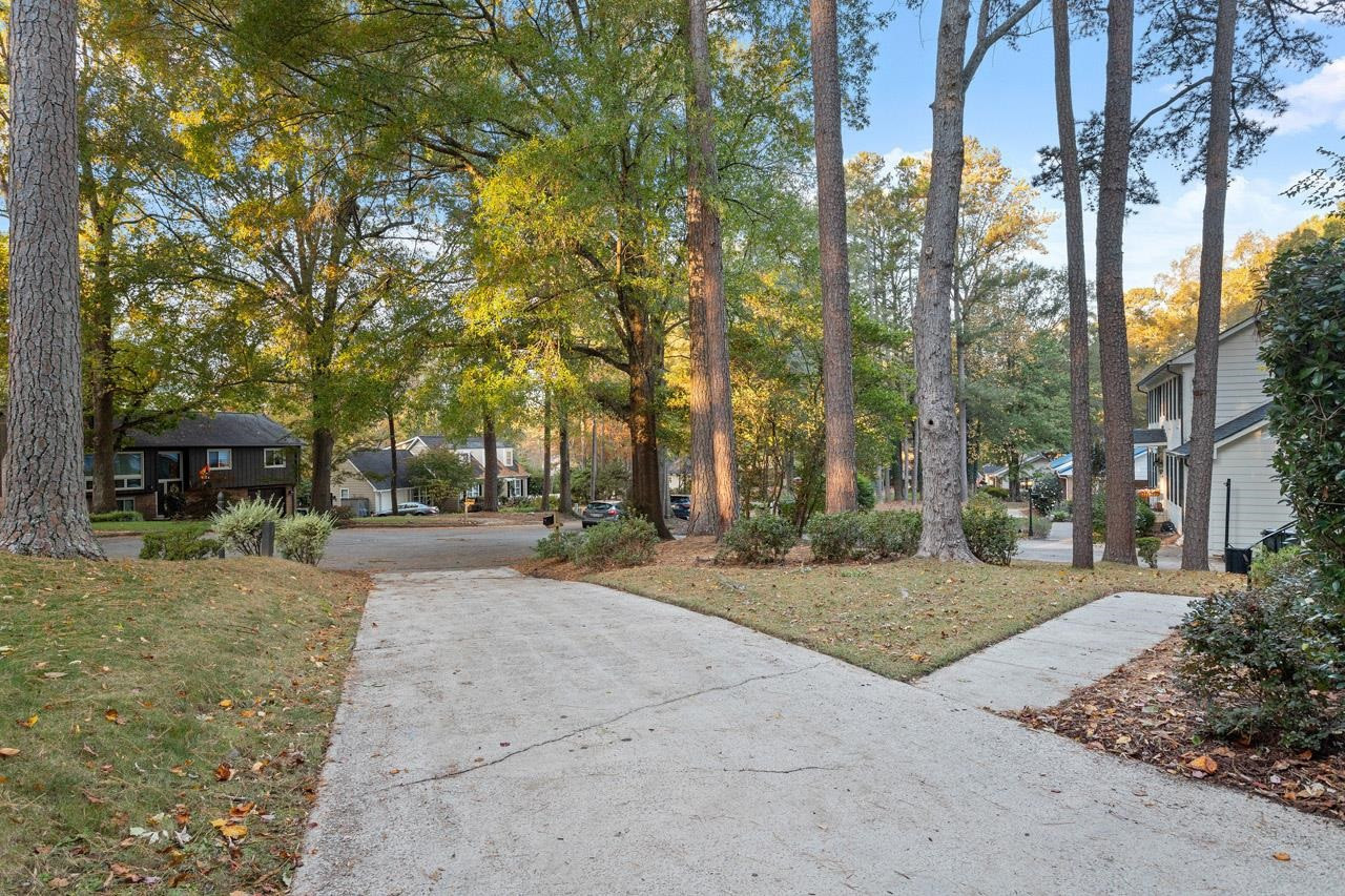 809 Silver Leaf Place Raleigh, NC 27609 - Photo 3 of 34 a view of a patio with table and chairs under a large tree
