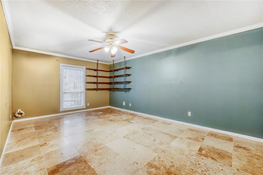 6851 Roswell Road, Unit M13 Atlanta, GA 30328 - Photo 18 of 28 a view of a big room with a chandelier fan and windows