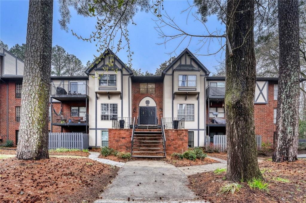 6851 Roswell Road, Unit M13 Atlanta, GA 30328 - Photo 23 of 28 a front view of a house with garden