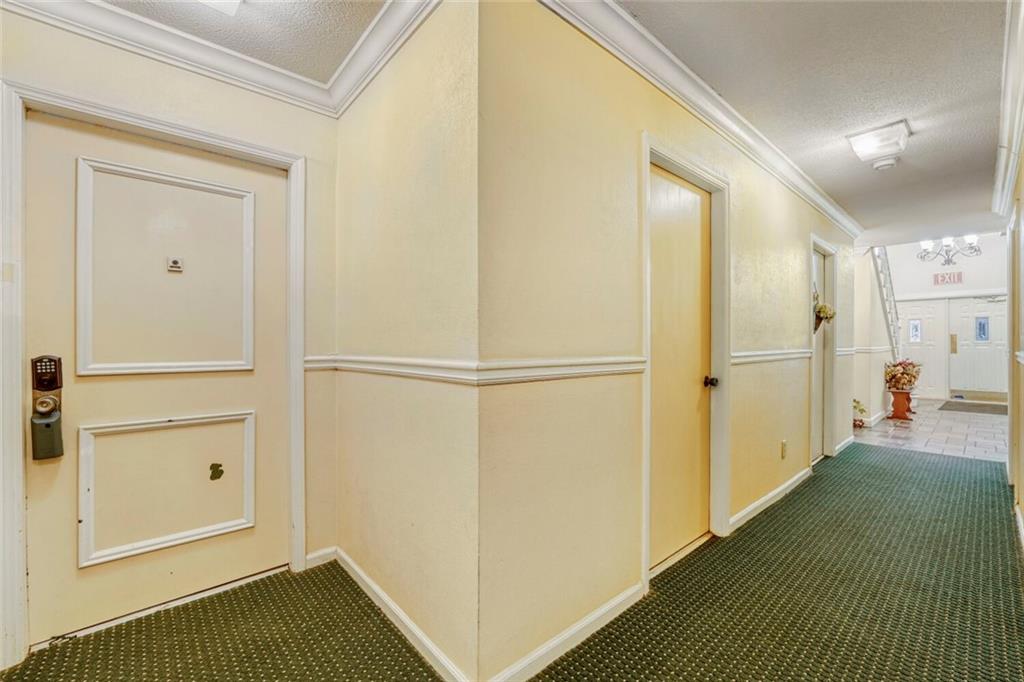 6851 Roswell Road, Unit M13 Atlanta, GA 30328 - Photo 25 of 28 a view of a hallway with closet and wooden floor