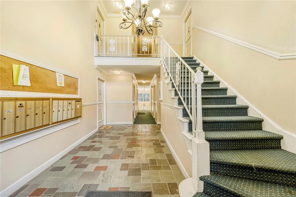 6851 Roswell Road, Unit M13 Atlanta, GA 30328 - Photo 26 of 28 a view of a hallway with wooden floor and staircase