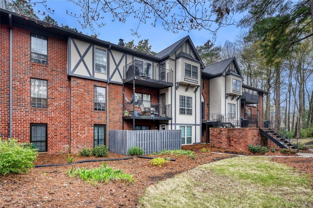 6851 Roswell Road, Unit M13 Atlanta, GA 30328 - Photo 27 of 28 a front view of a house with a yard
