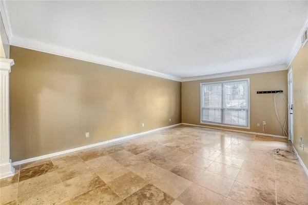 a view of an empty room with a window