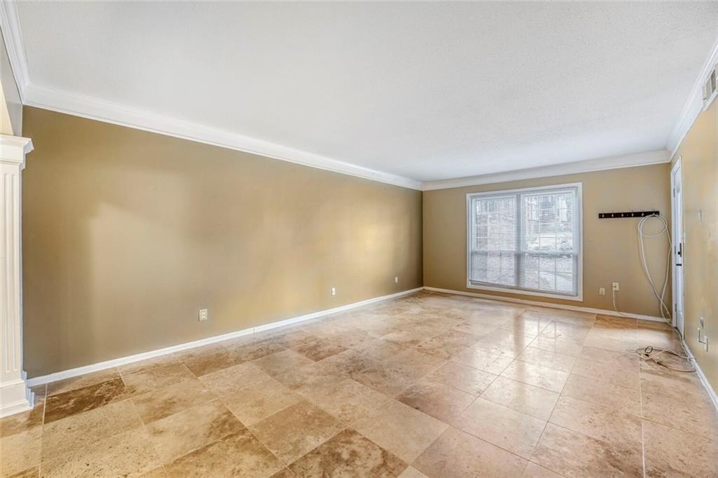 6851 Roswell Road, Unit M13 Atlanta, GA 30328 - Photo 3 of 28 a view of an empty room with a window
