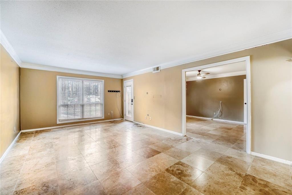 6851 Roswell Road, Unit M13 Atlanta, GA 30328 - Photo 4 of 28 a view of an empty room with window and wooden floor