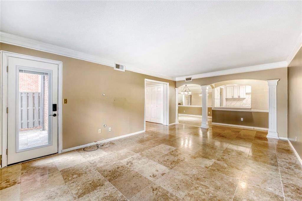 6851 Roswell Road, Unit M13 Atlanta, GA 30328 - Photo 5 of 28 an empty room with large windows