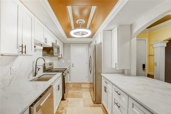 a kitchen with stainless steel appliances granite countertop a sink and a stove