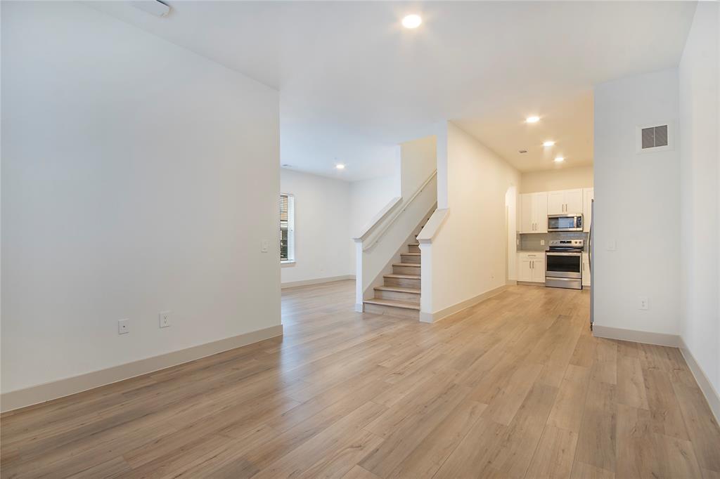4700 West Spring Creek Parkway, Unit 9103 Plano, TX 75024 - Photo 12 of 40 a view of a room with wooden floor and stairs