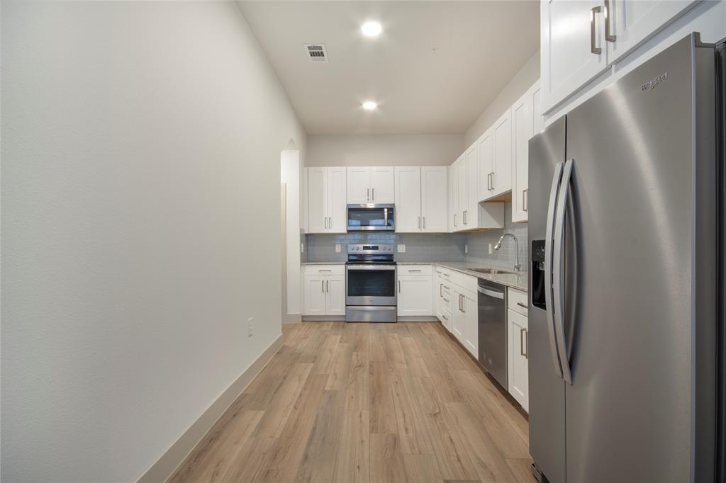 4700 West Spring Creek Parkway, Unit 9103 Plano, TX 75024 - Photo 15 of 40 a kitchen with a refrigerator a sink and dishwasher