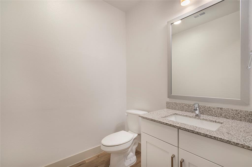 4700 West Spring Creek Parkway, Unit 9103 Plano, TX 75024 - Photo 16 of 40 a bathroom with a granite countertop sink toilet and a mirror