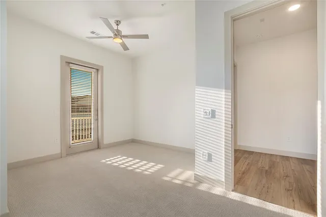 a view of a livingroom with a ceiling fan and window