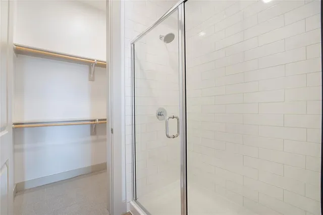 a bathroom with a glass shower door