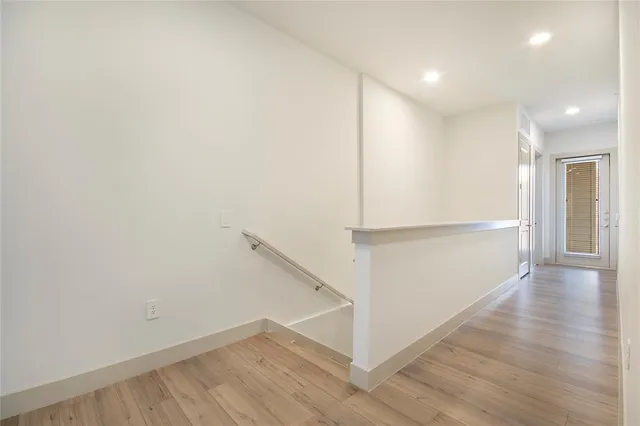 a view of a hallway with wooden floor