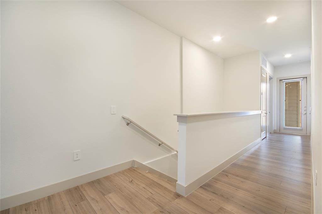 4700 West Spring Creek Parkway, Unit 9103 Plano, TX 75024 - Photo 21 of 40 a view of a hallway with wooden floor