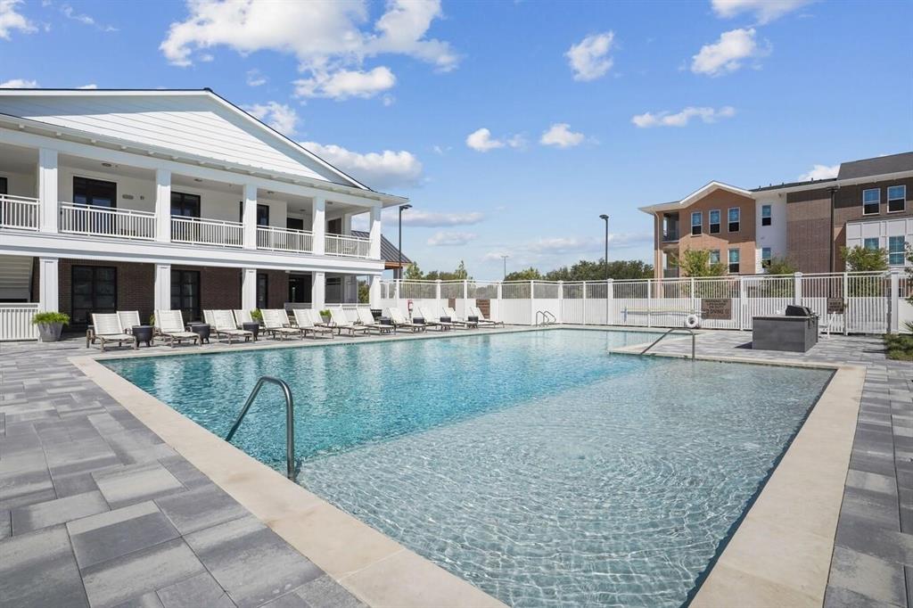 4700 West Spring Creek Parkway, Unit 9103 Plano, TX 75024 - Photo 33 of 40 a view of a swimming pool with a lounge chairs