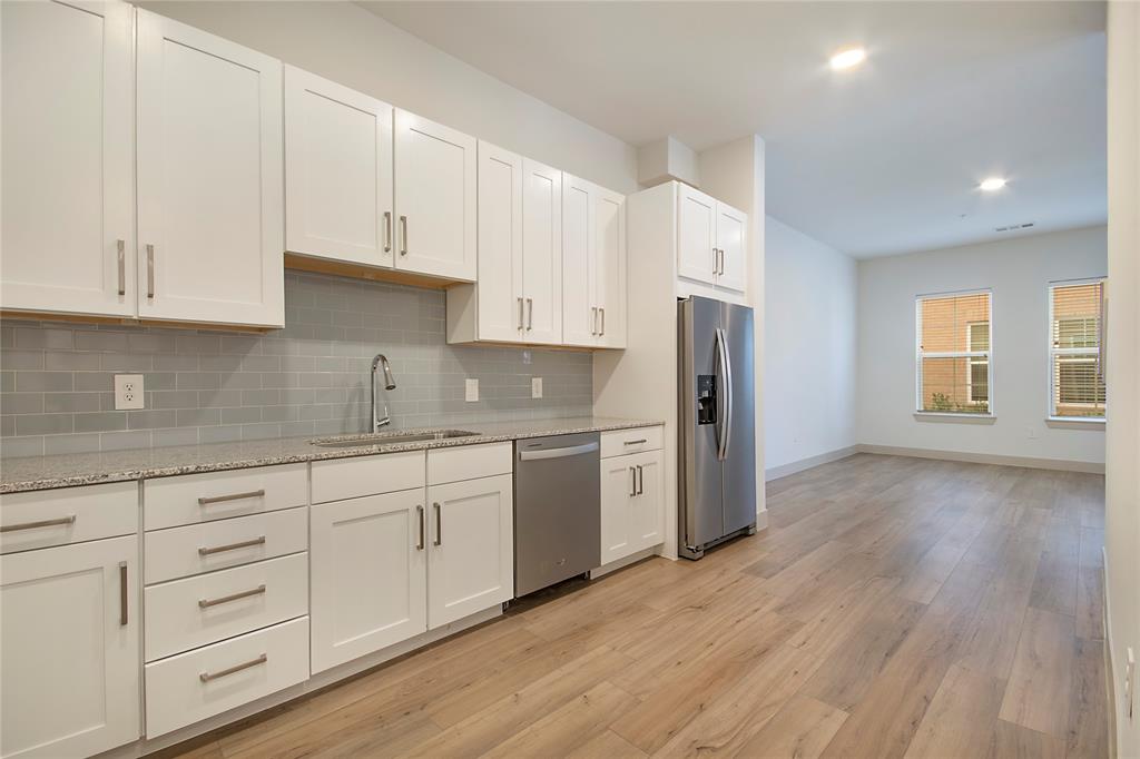 4700 West Spring Creek Parkway, Unit 9103 Plano, TX 75024 - Photo 4 of 40 a kitchen with granite countertop white cabinets and refrigerator