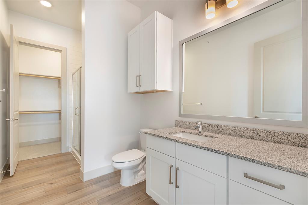 4700 West Spring Creek Parkway, Unit 9103 Plano, TX 75024 - Photo 8 of 40 a bathroom with a granite countertop sink and a toilet