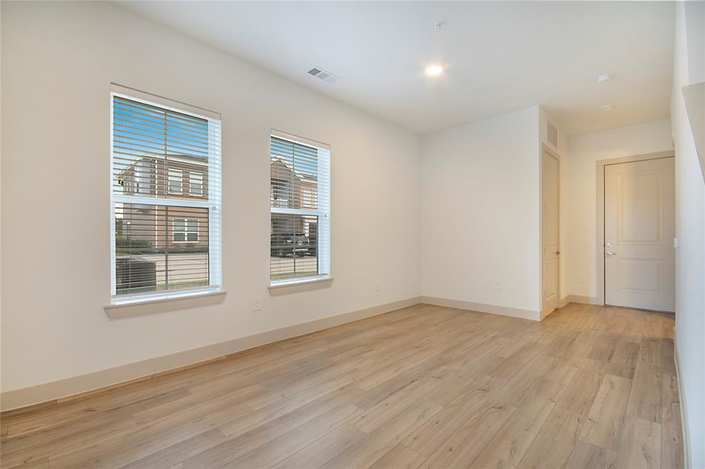 4700 West Spring Creek Parkway, Unit 9103 Plano, TX 75024 - Photo 9 of 40 a view of an empty room with wooden floor and a window