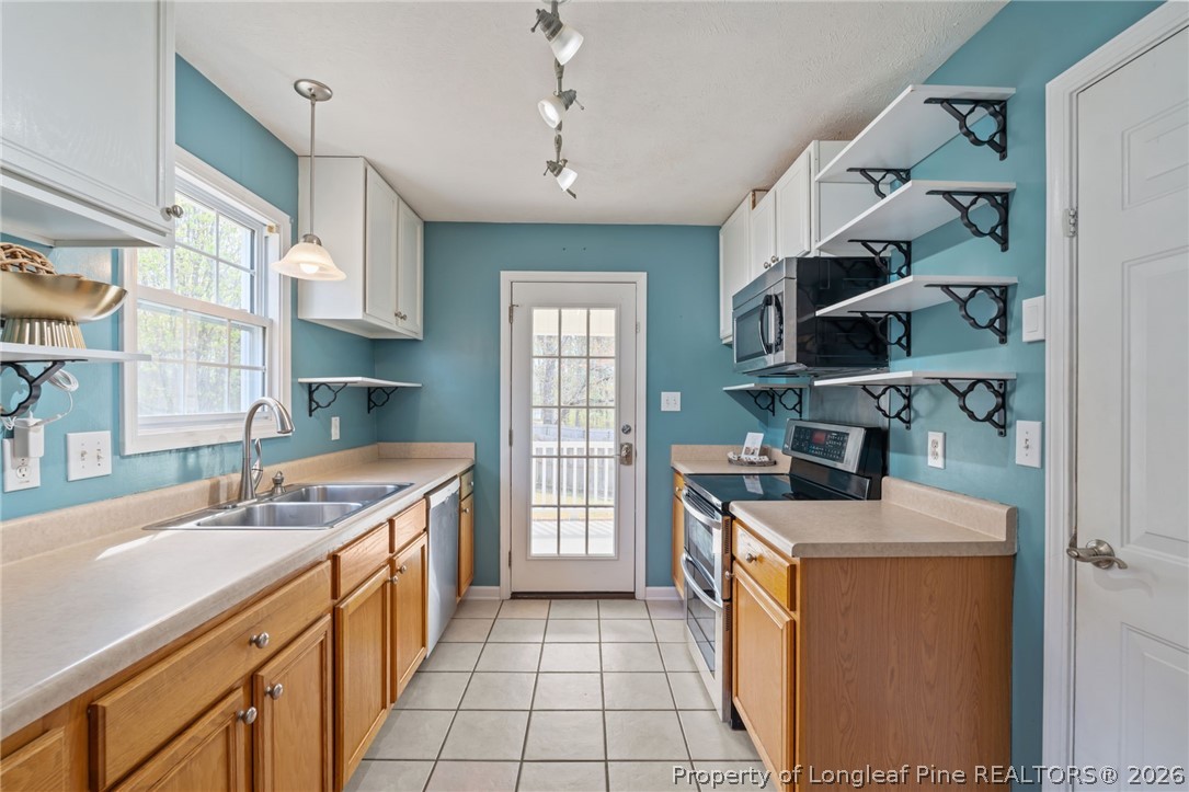 115 Shelby Street Spring Lake, NC 28390 - Photo 15 of 40 a kitchen with a sink stove and cabinets