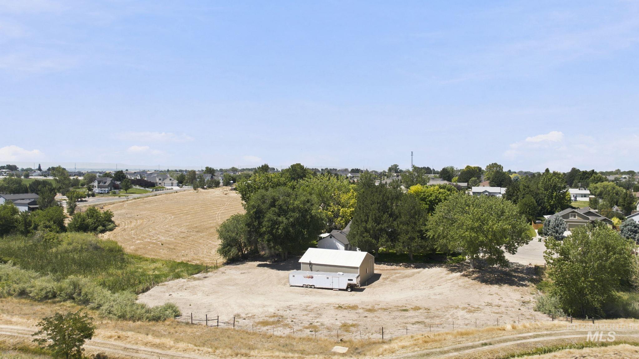 24864 Coventry Drive Caldwell, ID 83607 - Photo 36 of 49 Expansive land parcel featuring a single-story structure with a light-colored roof