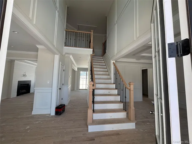 a view of entryway and hall with wooden floor