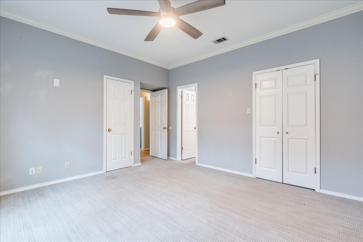 3809 Spicewood Springs Road, Unit 127 Austin, TX 78759 - Photo 13 of 29 An airy bedroom with plush carpeting and a modern ceiling fan, offering comfortable living.